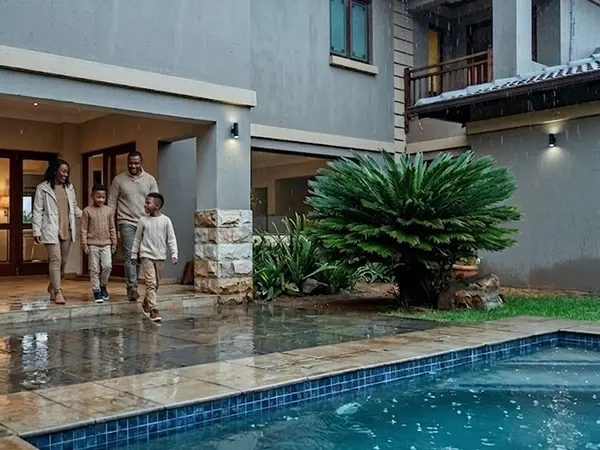 Rainy day family walking out on the patio.